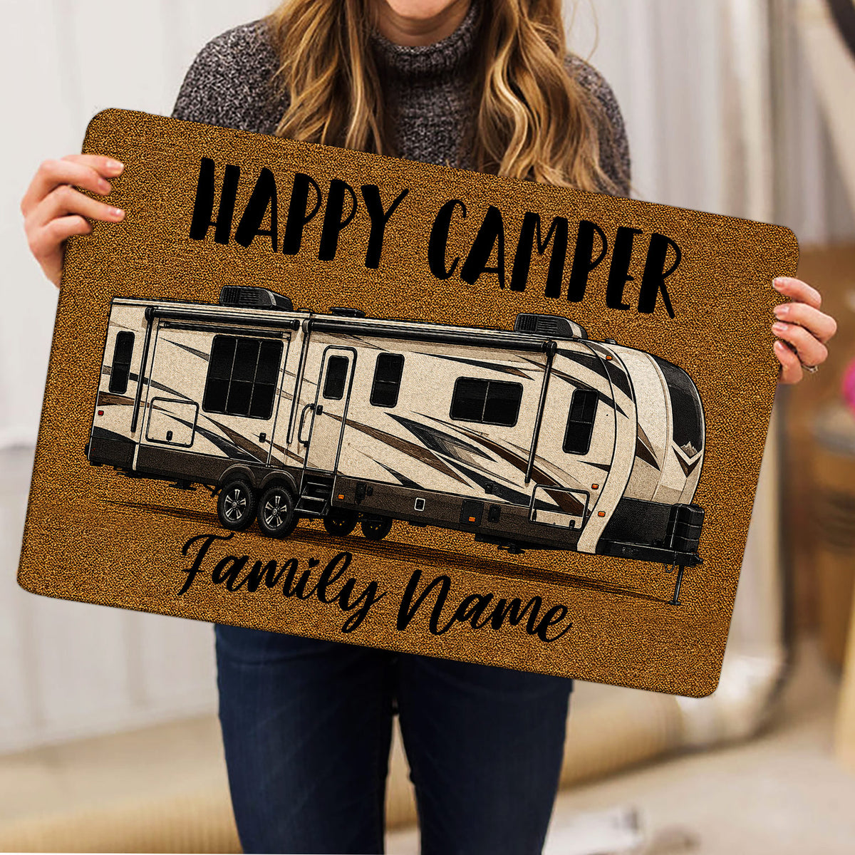 Camping RV doormat held indoors, featuring a detailed travel trailer illustration and welcoming camper artwork