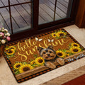 Yorkie entryway mat shown beside a glass door with sunflower artwork and a warm rustic home setting