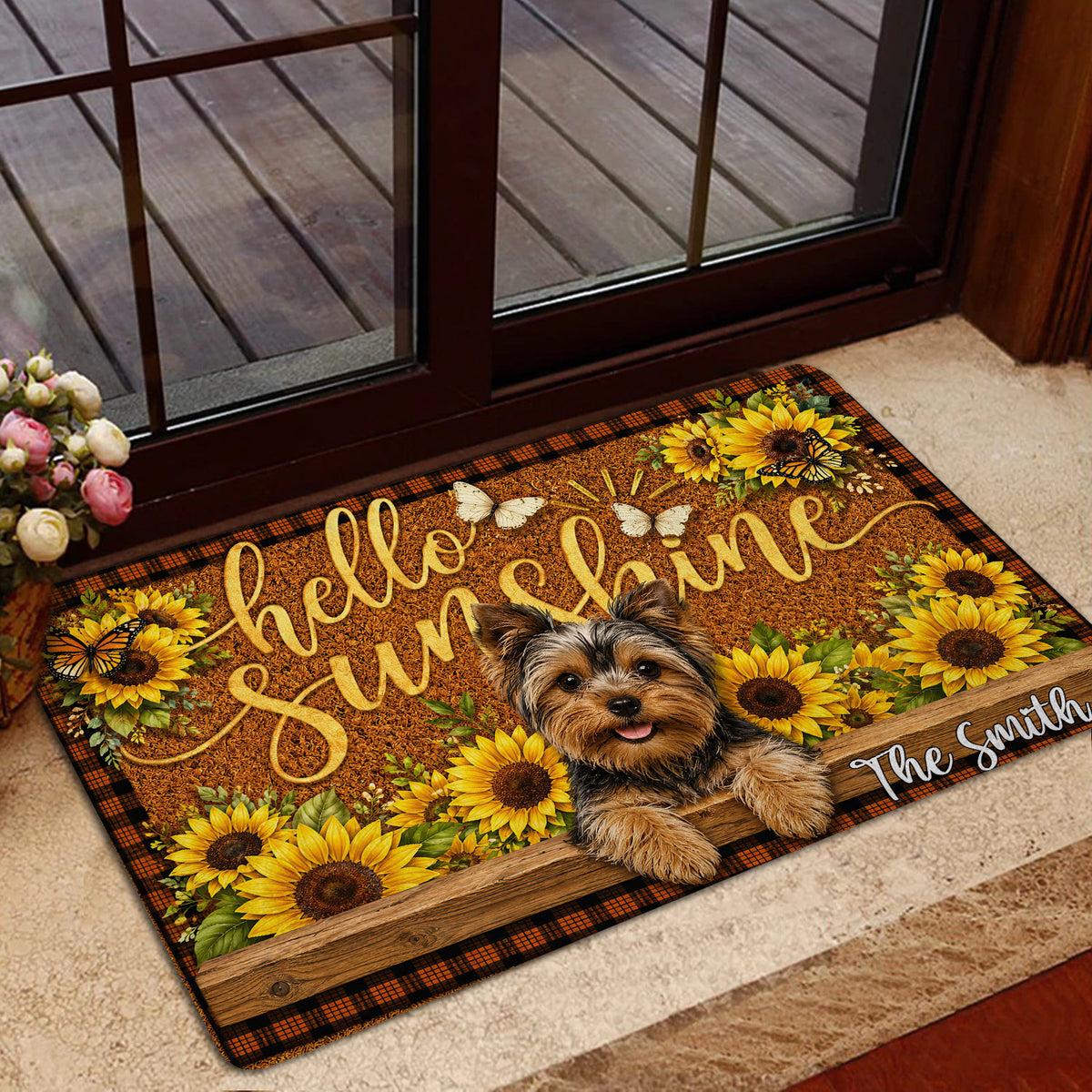 Yorkie entryway mat shown beside a glass door with sunflower artwork and a warm rustic home setting