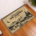 Camping entryway rug beside a white door featuring RV, tent, mountains and campfire artwork