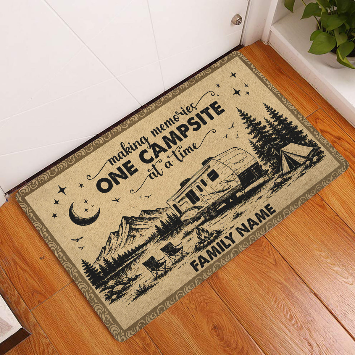 Camping entryway rug beside a white door featuring RV, tent, mountains and campfire artwork