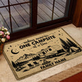 Camping-themed entryway mat by a glass door with RV, tent, campfire and mountain artwork