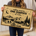 Camping doormat held indoors showing RV, tent, campfire, mountains and pine tree artwork