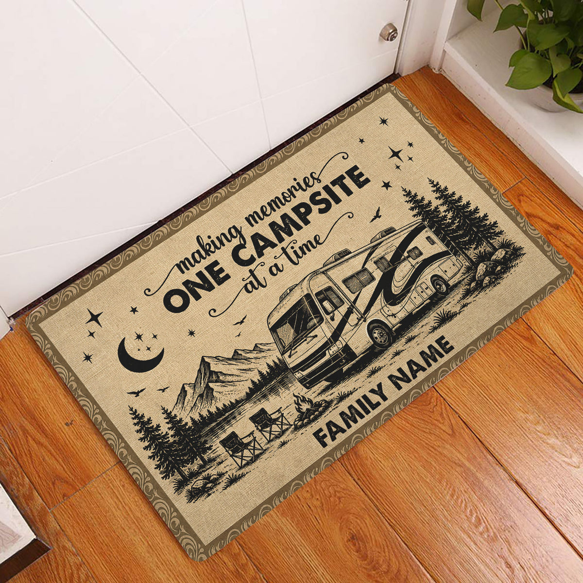 Camping RV doormat displayed at a home entryway on hardwood flooring with mountain and campsite artwork
