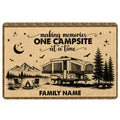 Camping doormat with mountain campsite, camper trailer, campfire, pine trees, stars, and a rustic brown border