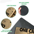 Close-up feature view showing the camping doormat surface, thin profile, and dark rubber backing