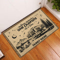 Camping entryway rug displayed on a wood floor beside a door with a mountain and camper scene