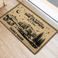 Rustic camping door mat placed near an entrance, featuring an RV, mountains, trees, stars, and campfire artwork