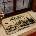 Camping-themed entryway mat displayed by a glass door with RV, mountain, pine tree, and campfire illustration