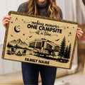 Person holding a rustic camping doormat featuring an RV campsite, mountains, trees, stars, and campfire design