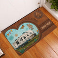 Camping entryway rug displayed by a door with a travel trailer, campfire, flowers, and rustic brown border