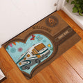 Camping entryway mat displayed by a front door on hardwood flooring with a motorhome and campfire design