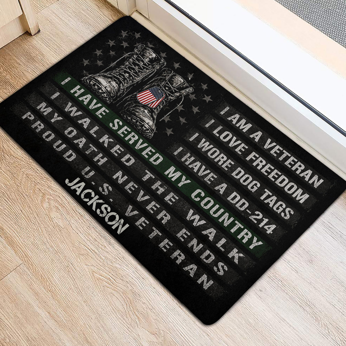 Black veteran door mat positioned by a doorway with military boots, stars, and bold patriotic lettering