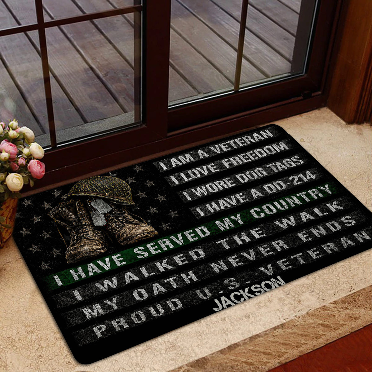 Veteran doormat displayed near a glass door with military imagery, patriotic stars, and bold tribute lettering