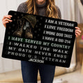 Person holding a veteran doormat featuring military boots, helmet, dog tags, stars, and a patriotic service tribute