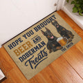 Doberman beer-themed doormat styled by a white front door on a hardwood floor