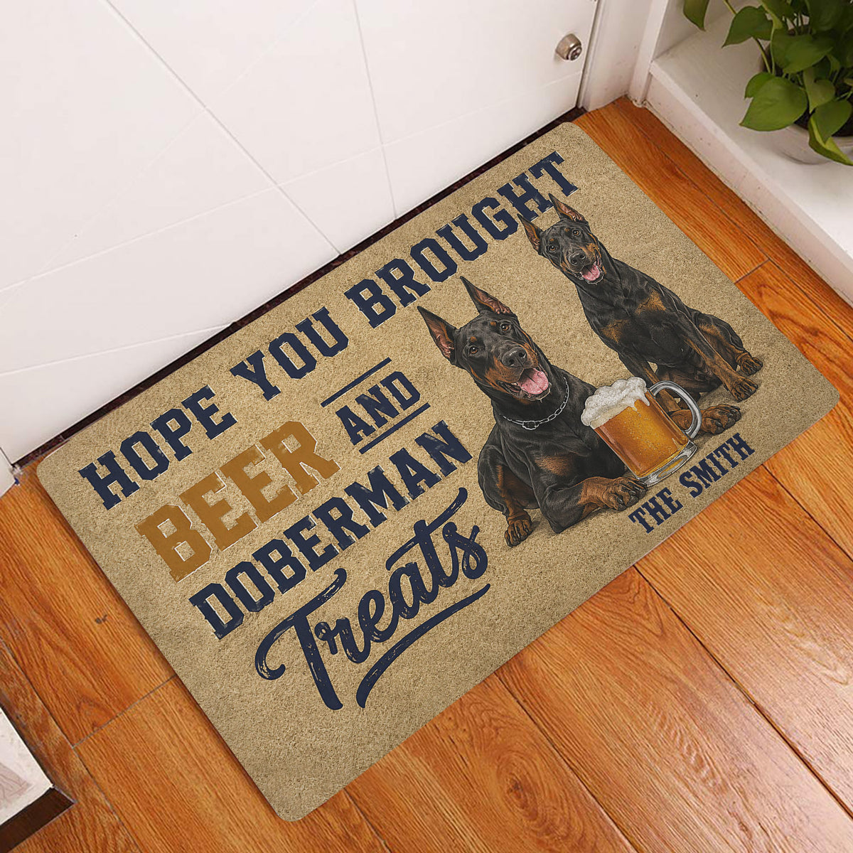 Doberman beer-themed doormat styled by a white front door on a hardwood floor