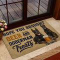 Doberman beer-themed door mat shown in a home entrance near a glass door