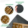 Close-up feature view showing the doormat print, 3 mm thickness, and black rubber backing