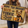 Person holding a Yorkie doormat featuring a cheerful terrier, beer mug and vintage design