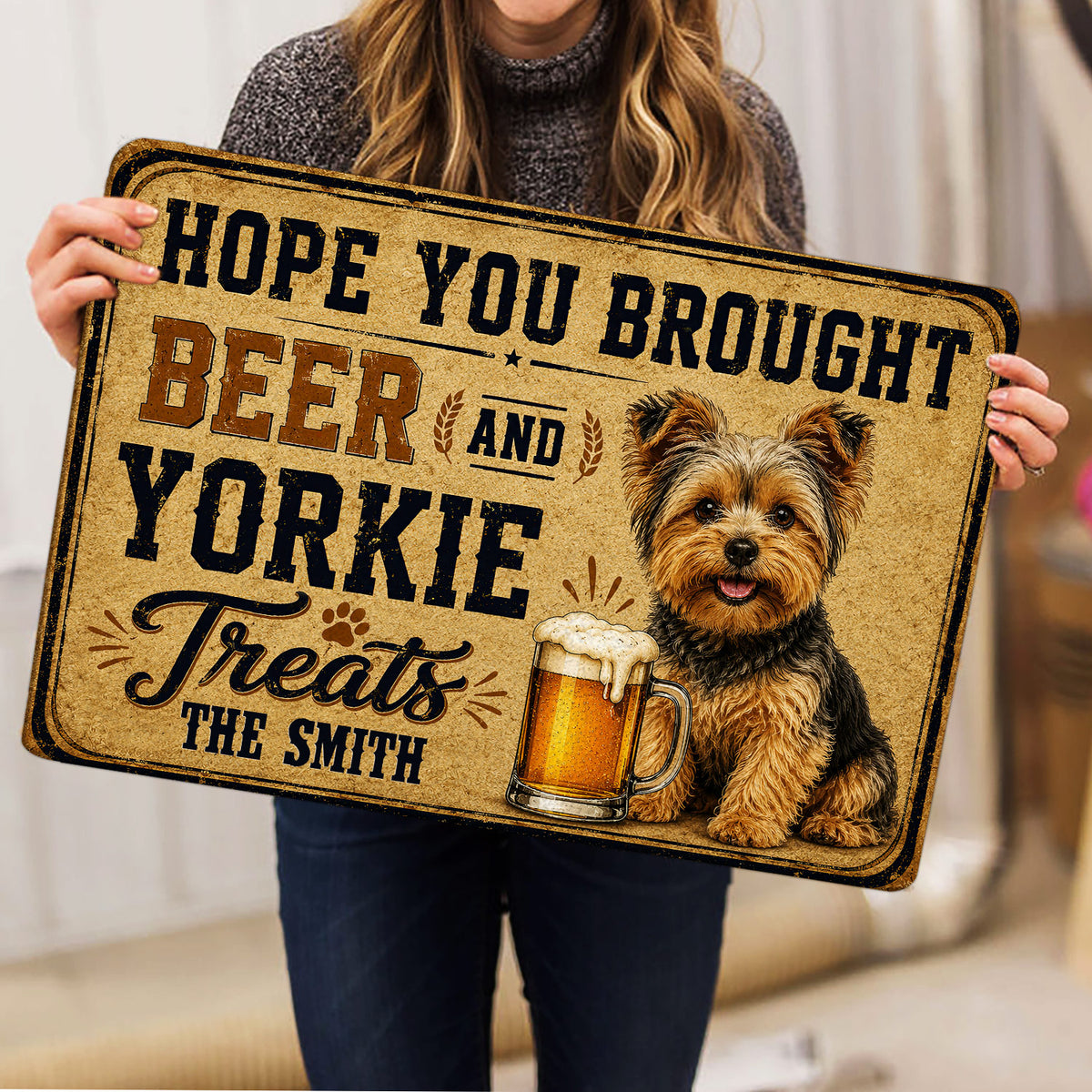 Person holding a Yorkie doormat featuring a cheerful terrier, beer mug and vintage design