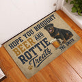 Rottweiler beer-themed doormat displayed at an indoor entryway on a hardwood floor