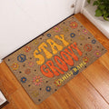 Groovy hippie doormat styled in a bright home entryway with flowers and peace symbols