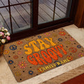 Colorful flower-power doormat displayed in a warm home entrance with glass doors