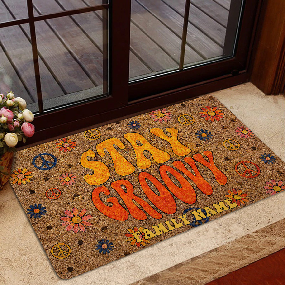 Colorful flower-power doormat displayed in a warm home entrance with glass doors