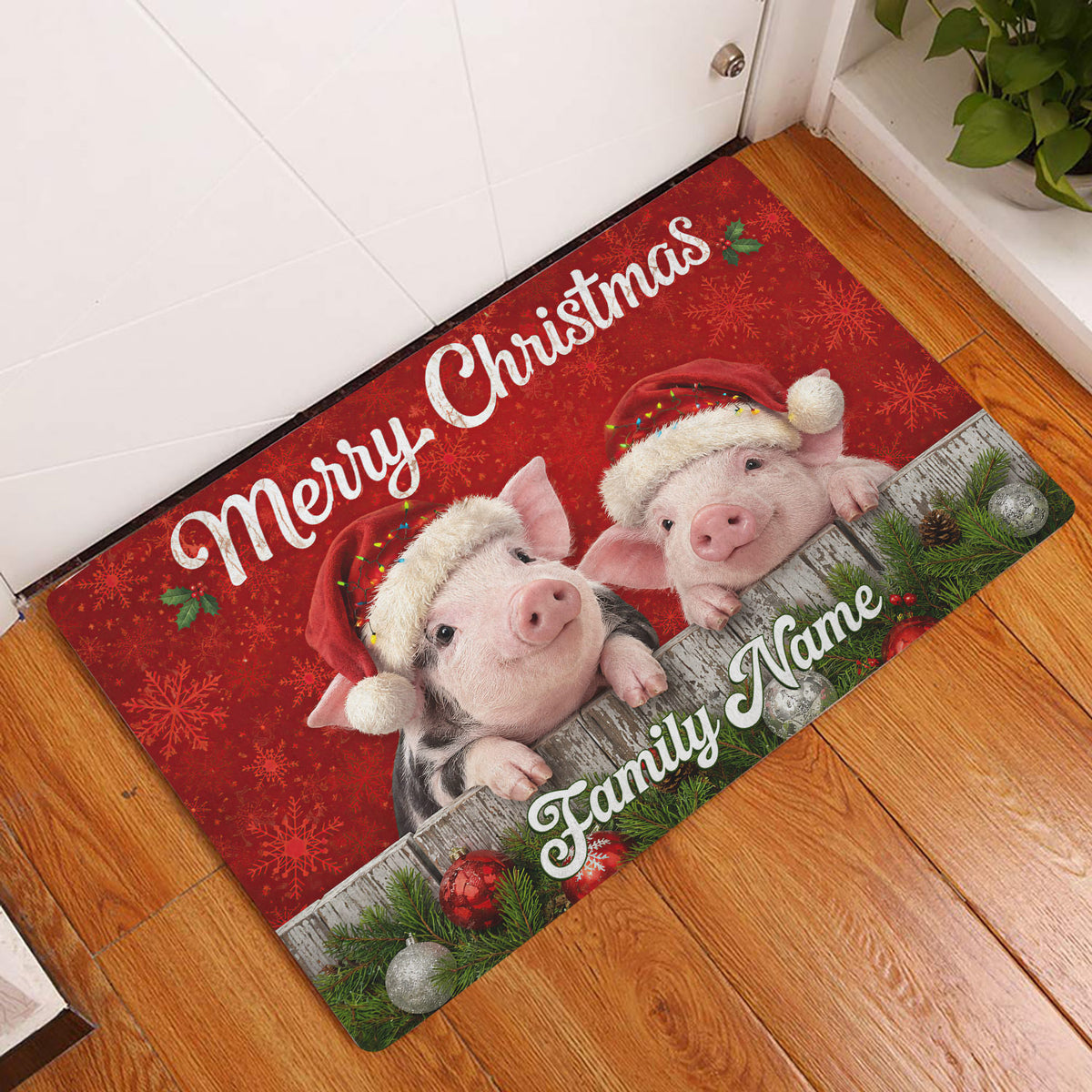 Christmas pig entryway rug displayed on a wood floor beside a white door with festive red artwork