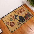Christmas tuxedo cat entryway mat displayed beside a white door on wood flooring