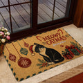 Festive tuxedo cat doormat displayed near a glass door in a home entryway