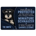Miniature Schnauzer doormat with bold blue lettering, paw prints, and a playful protective house message