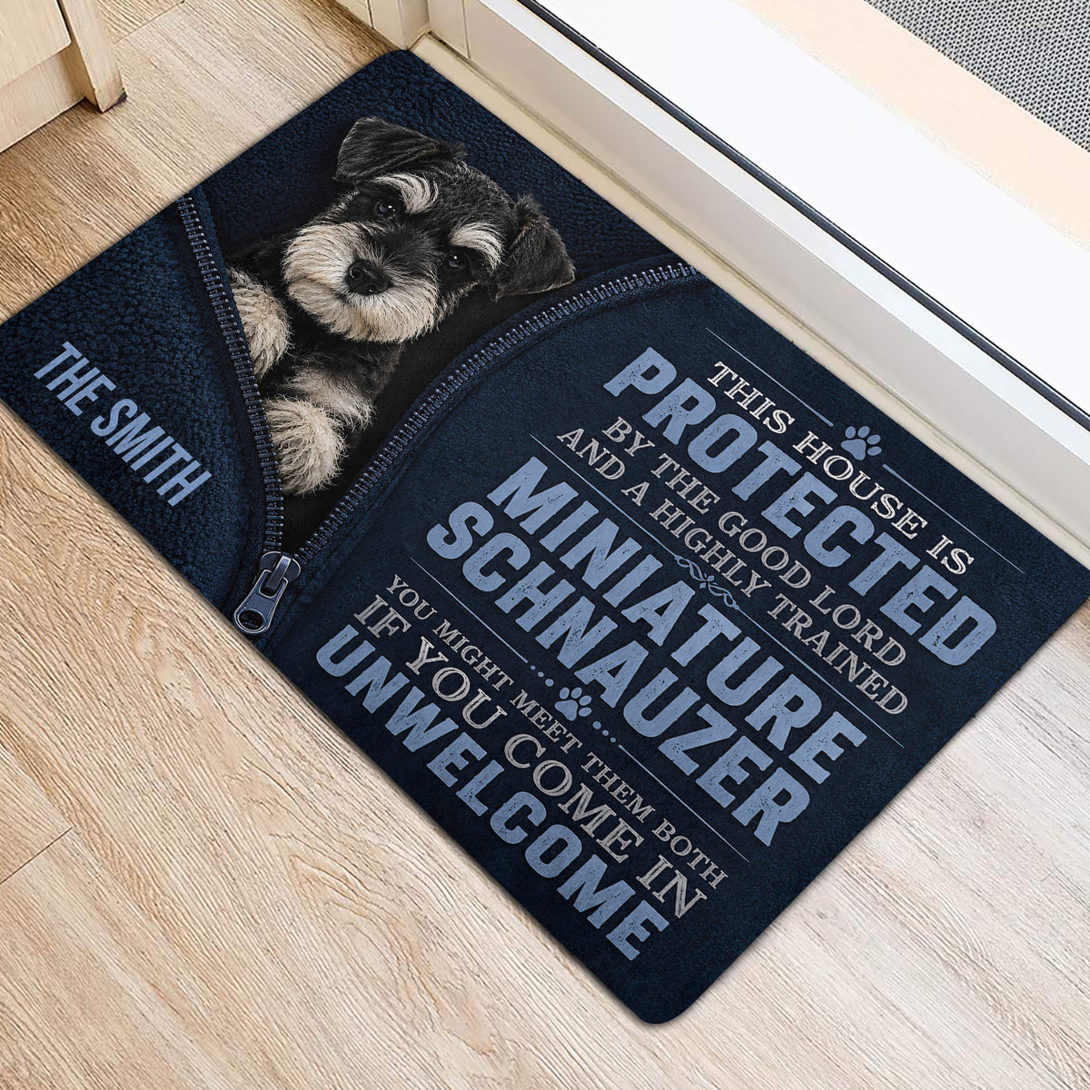 Miniature Schnauzer door mat styled at an indoor entrance with bold protective house lettering