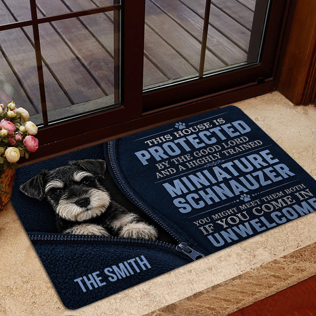 Miniature Schnauzer doormat presented near a glass door with a dark blue dog-themed design