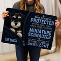 Miniature Schnauzer doormat lifestyle presentation held indoors, showing the dog portrait and typography