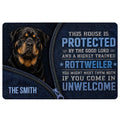 Rottweiler doormat featuring a black and tan dog, blue artwork, and a bold protective entryway message