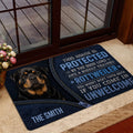Rottweiler entryway mat displayed by a glass door with a black and tan dog portrait