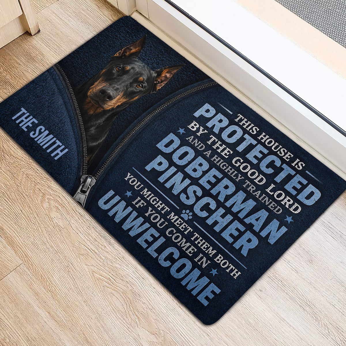 Doberman entryway mat positioned beside a glass door on a light wood floor