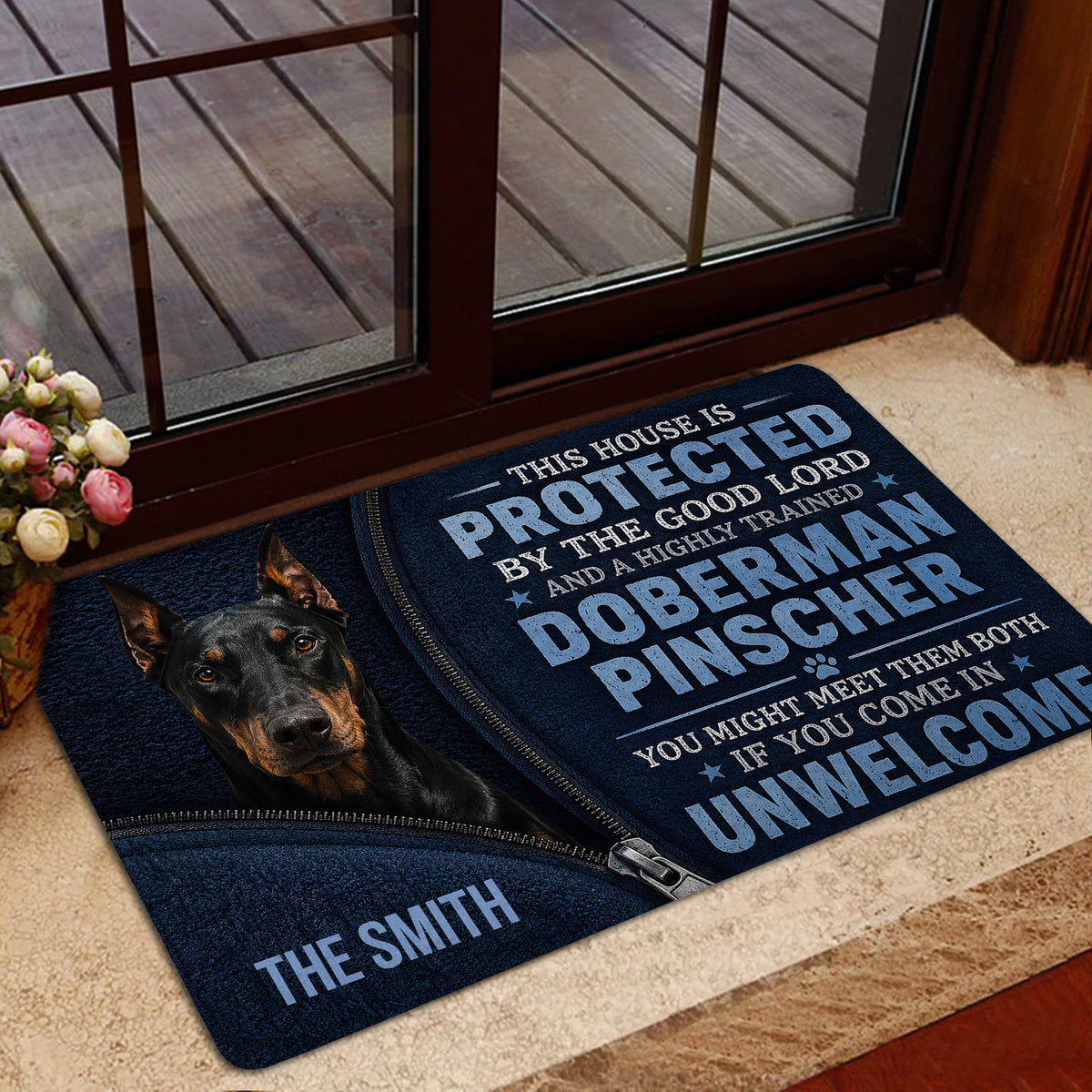 Doberman doormat styled inside a home entrance near a glass door and deck