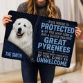 Person holding a Great Pyrenees doormat featuring a white dog portrait and bold navy typography