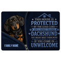 Black and tan dachshund doormat with a protective home message and dark blue artwork