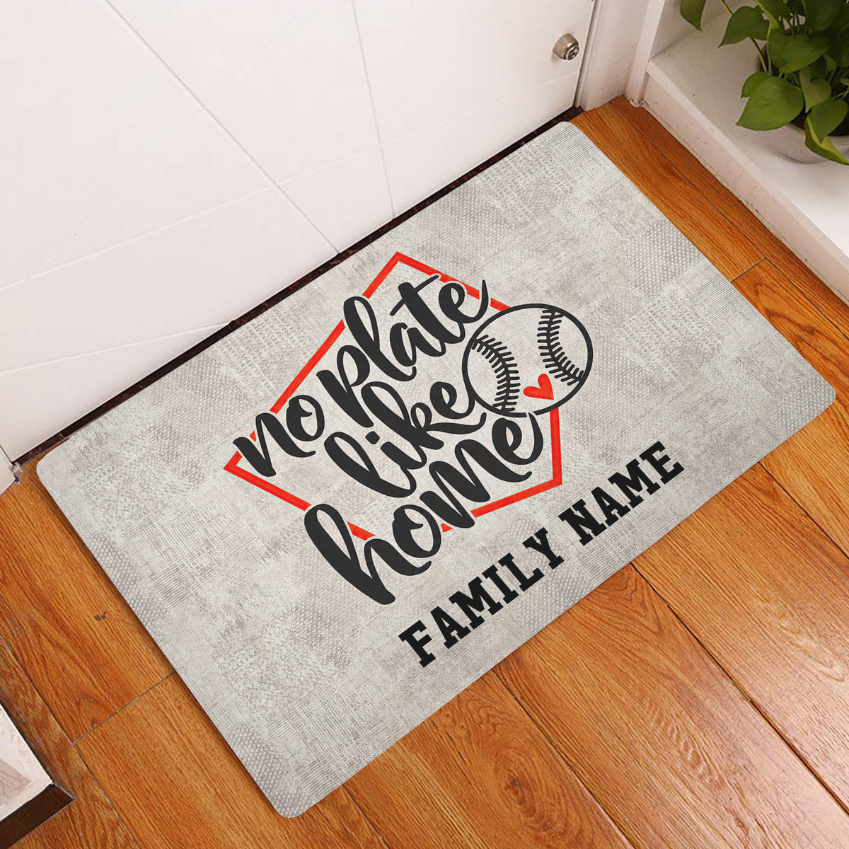 Baseball entryway rug displayed beside a white door on warm wood flooring