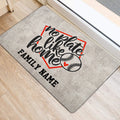 Baseball-themed door mat positioned near an entrance, featuring script lettering and baseball artwork