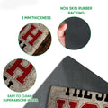 Baseball doormat detail showing the printed felt surface, rounded edge, and black rubber underside