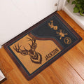 Hunting doormat displayed at an indoor entryway with deer artwork on a warm wood floor