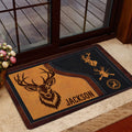 Hunting-themed entryway rug displayed near a glass door with deer and antler artwork