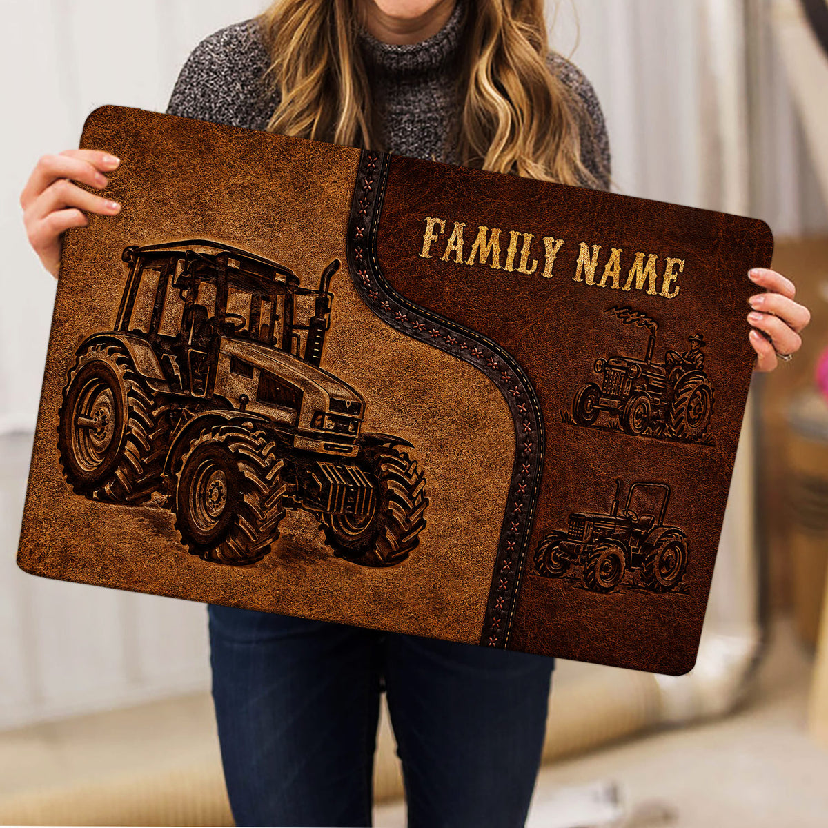 Person holding a rectangular tractor doormat featuring detailed farm machinery artwork in brown and black