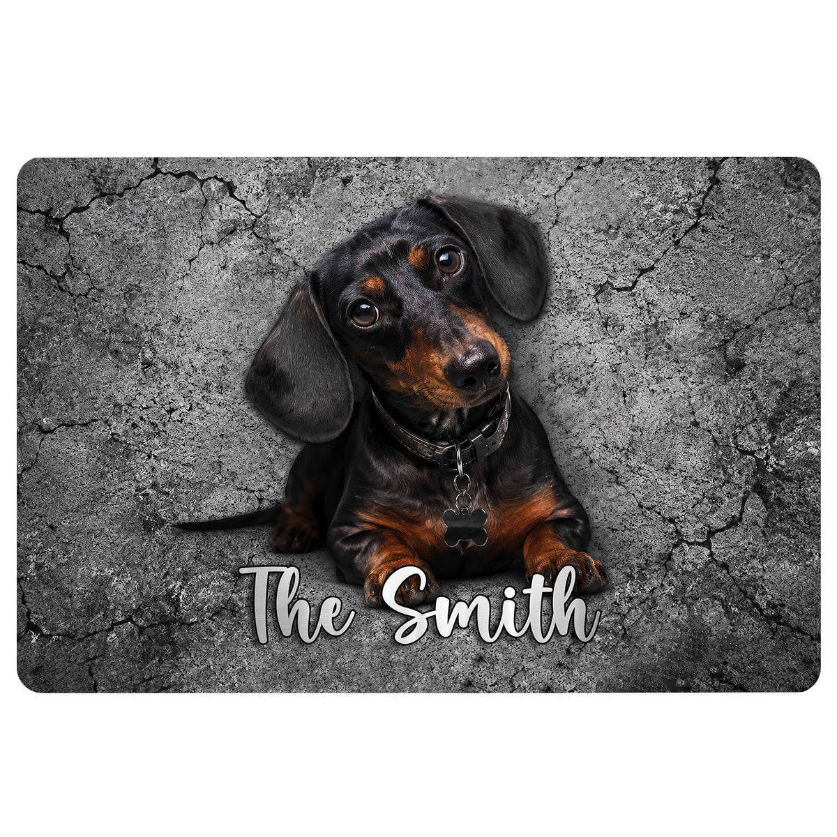 Black and tan dachshund portrait on a cracked gray stone-style doormat with decorative script lettering