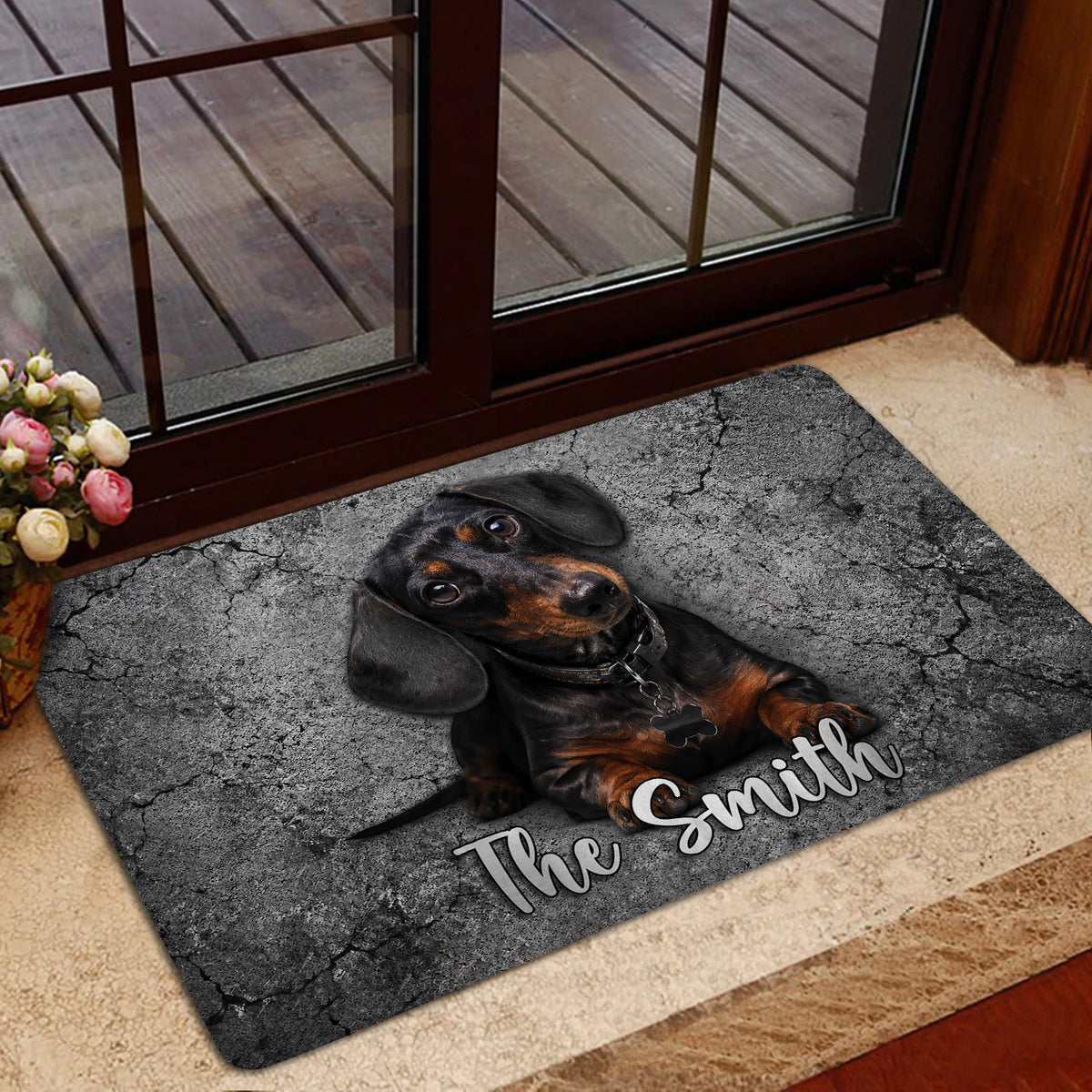 Dachshund doormat styled in a home entrance beside a glass door and indoor flooring